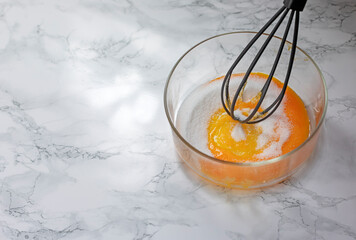Egg yolks, sugar and whisk to whip them.