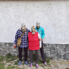 Plakat Gas masks. Three people with gas masks and brick wall behind with copy space. Danger of chemical weapon.