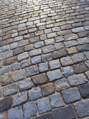 Abstract background of old cobblestone pavement close-up.