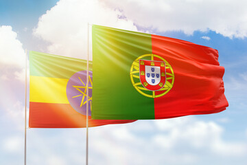 Obraz premium Sunny blue sky and flags of portugal and ethiopia