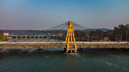 isolated cable bridge over ganges river with colorful sky at evening
