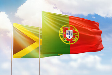 Sunny blue sky and flags of portugal and jamaica