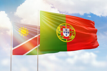 Sunny blue sky and flags of portugal and namibia