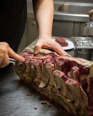 Cook Hands Cutting a Dry Aged Rib Eye