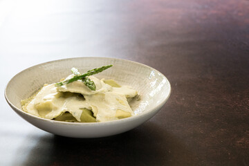Spinach and Walnut Ravioli with Gorgonzola Sauce. Fresh Homemade Pasta with Creamy Italian Cheese