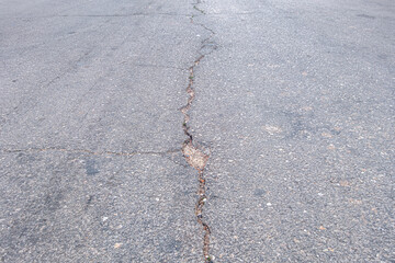 abstract background of an old cracked asphalt, perspective view