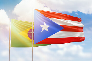 Sunny blue sky and flags of puerto rico and brazil