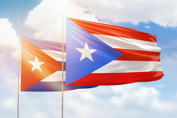 Sunny blue sky and flags of puerto rico and cuba