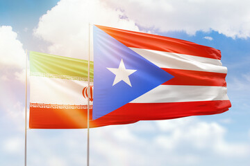 Sunny blue sky and flags of puerto rico and iran