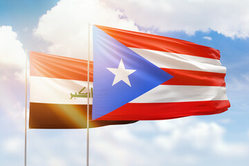 Sunny blue sky and flags of puerto rico and iraq