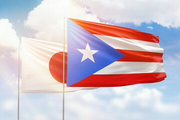 Sunny blue sky and flags of puerto rico and japan