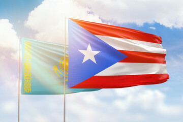Sunny blue sky and flags of puerto rico and kazakhstan