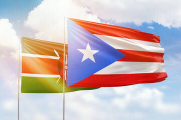 Sunny blue sky and flags of puerto rico and kenya