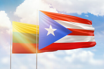Sunny blue sky and flags of puerto rico and lithuania