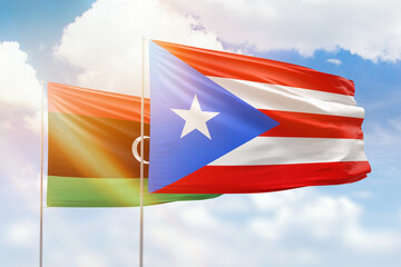 Sunny blue sky and flags of puerto rico and libya