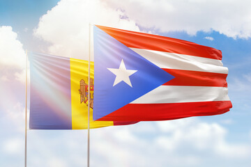 Sunny blue sky and flags of puerto rico and moldova