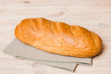 Assortment of freshly baked bread with napkin on rustic table top view. Healthy unleavened bread. French bread