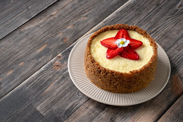 New York cheesecake is a dessert that is an open pie or even a cake. Decorated with strawberries. It consists of two main parts: sand base and cheese filling.