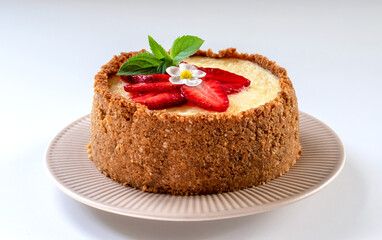 New York cheesecake is a dessert that is an open pie or even a cake. Decorated with strawberries. It consists of two main parts: sand base and cheese filling. White background.