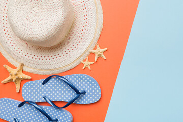 Summer vacation concept flat lay. straw hat beach accessories and flip flop top view. Space for...
