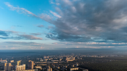 Blue morning epic cloudy skyscape in summer city residential district. Aerial view above buildings and streets, Kharkiv Ukraine