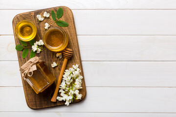 honey jar with acacia flowers and leaves. fresh honey top view flat lay