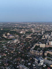 Aerial view Kharkiv city center residential area near Central park. Pavlove Pole and Center area with small and multistory high buildings in evening with street lights illumination. Vertical