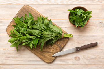 Bunch of fresh mint on the cutting boards, colored background top view