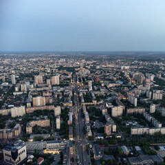 Fototapeta premium Aerial view Kharkiv city center Nauky avenue. Pavlove Pole and Central area with multistory high residential buildings in evening with street lights illumination