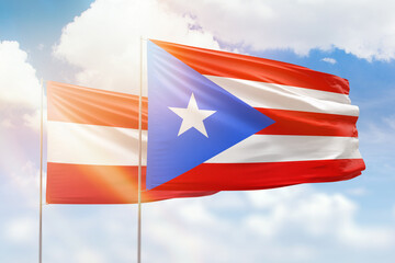 Sunny blue sky and flags of puerto rico and austria
