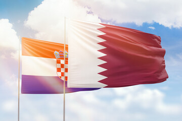 Sunny blue sky and flags of qatar and croatia