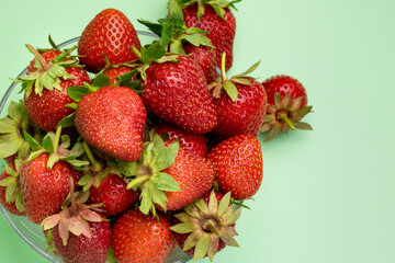 strawberries in a plate on an olive background