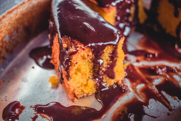 Close up piece of Brazilian carrot cake with chocolate frosting. Macro photo.