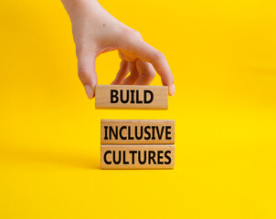 Build Inclusive Cultures symbol. Wooden blocks with words Build Inclusive Cultures. Beautiful...