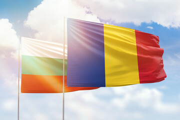 Sunny blue sky and flags of romania and bulgaria