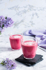 Delicious beetroot latte in glasses on the table. Healthy homemade vitamin drinks. Vertical view