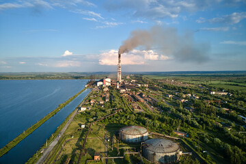 Aerial view of coal power plant high pipes with black smokestack polluting atmosphere. Electricity...