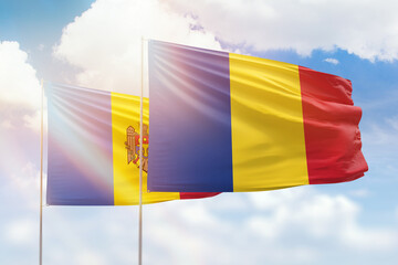Sunny blue sky and flags of romania and moldova