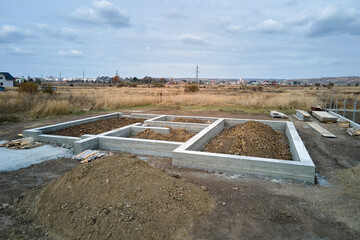 Top down aerial view of building works of new house concrete foundation on construction site