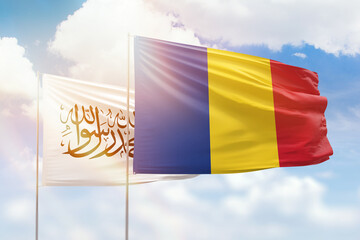 Sunny blue sky and flags of romania and afghanistan