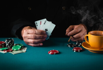 The player shows cards with a winning combination of three of a kind or set in a poker club. Luck...