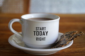 Morning coffee with crackers on the table with inspirational and motivational quote on the cup -...