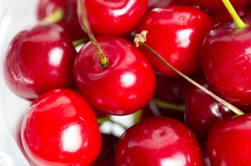 Bunch of cherries on transparent plate close-up natural background