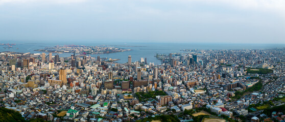 Panoramic aerial view of downtown Sannomiya and sprawling Kobe city at dusk