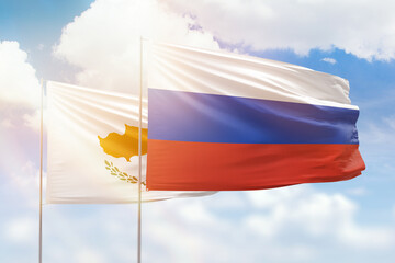 Sunny blue sky and flags of russia and cyprus