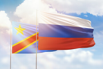 Sunny blue sky and flags of russia and dr congo