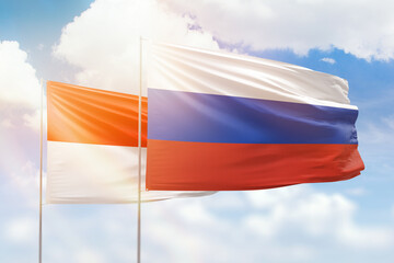 Sunny blue sky and flags of russia and indonesia