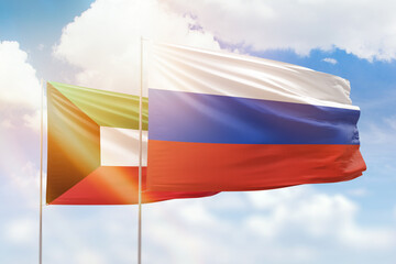 Sunny blue sky and flags of russia and kuwait