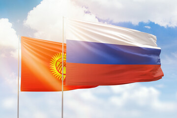 Sunny blue sky and flags of russia and kyrgyzstan