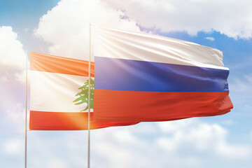 Sunny blue sky and flags of russia and lebanon